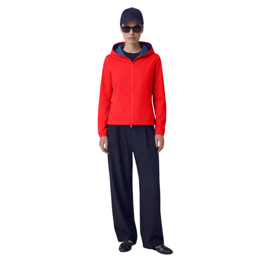 Person wearing a red jacket and black pants on a white background