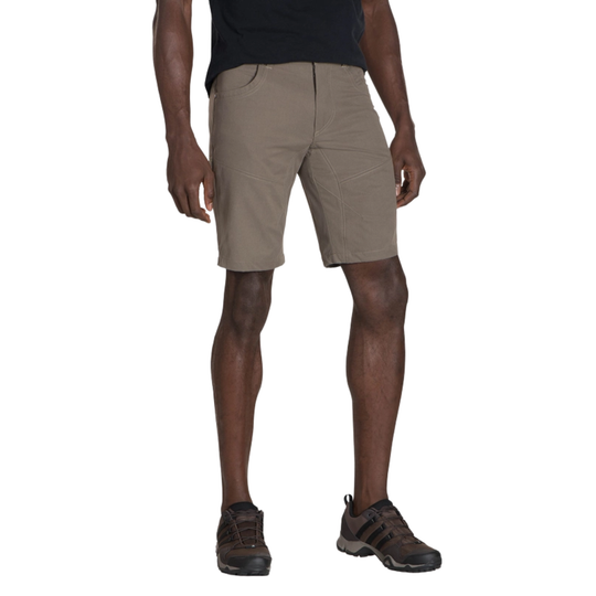 Beige shorts worn by a person on a white background