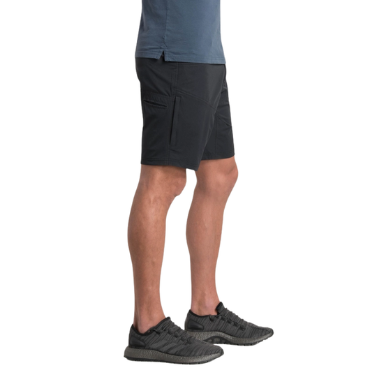 Person wearing black shorts and gray shoes on a white background