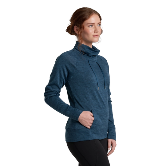 Woman wearing a blue cowl-neck sweater on a white background