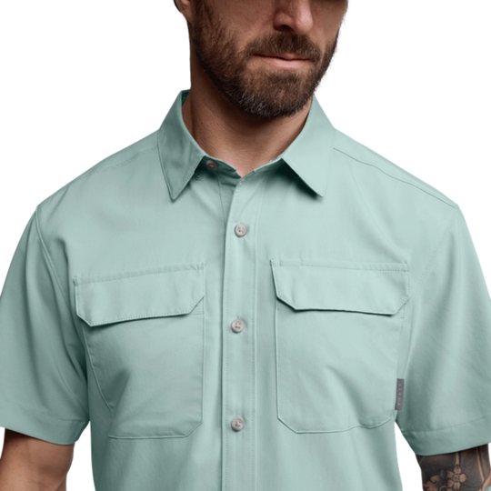 Light blue short-sleeve shirt worn by a person on a white background