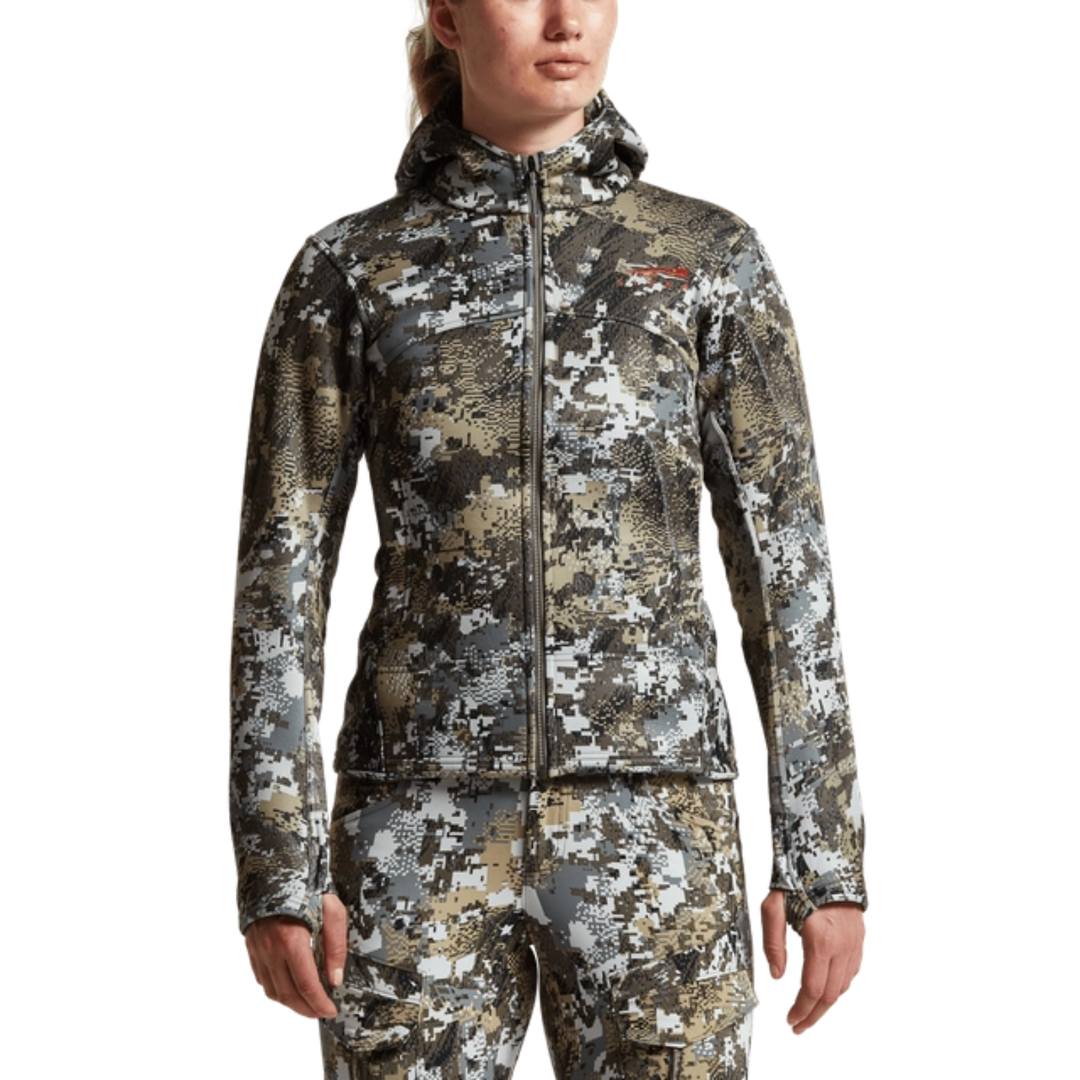 Person wearing a camouflage jacket and pants on a white background