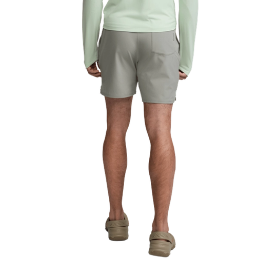 Person wearing light gray shorts on a white background