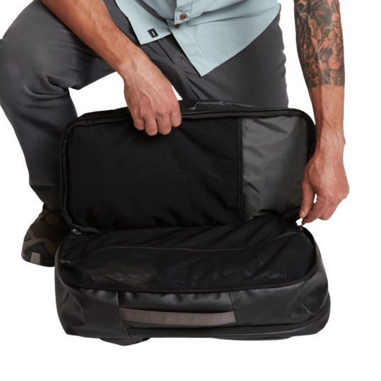 Person opening a black suitcase with a white background