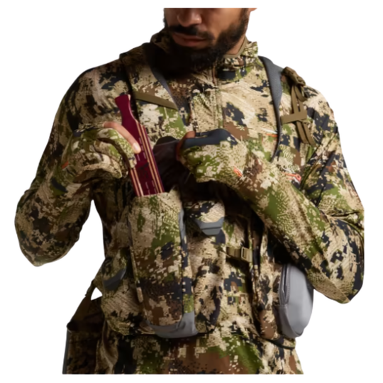 Person wearing a camouflage jacket holding a bow and quiver on a white background