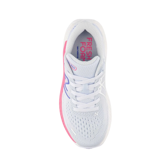 White athletic shoe with pink accents on a white background