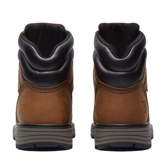 Pair of brown leather boots with black soles on a white background