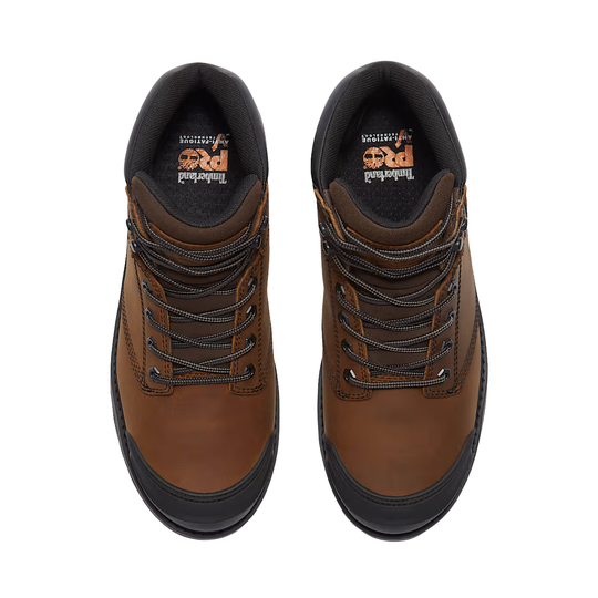 Pair of brown leather boots with black soles on a white background