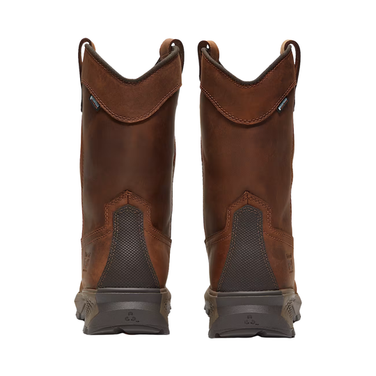Pair of brown leather boots with gray soles on a white background