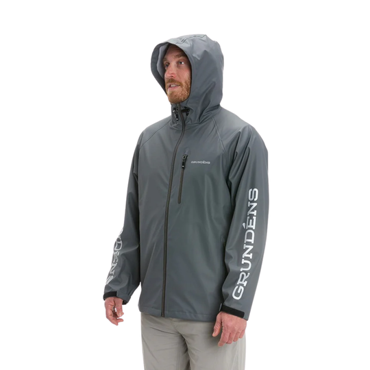 Person wearing a gray rain jacket with 'Grundéns' branding on a white background