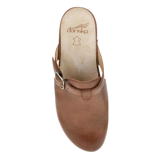 Brown leather clog shoe with 'Dansko' branding on a white background