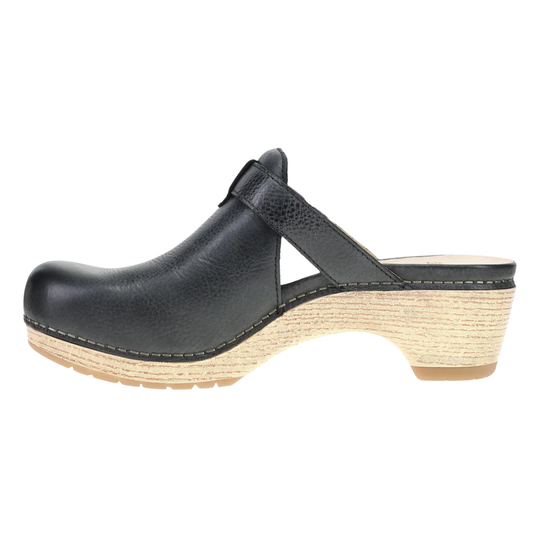 Black leather clog shoe with a strap on a white background
