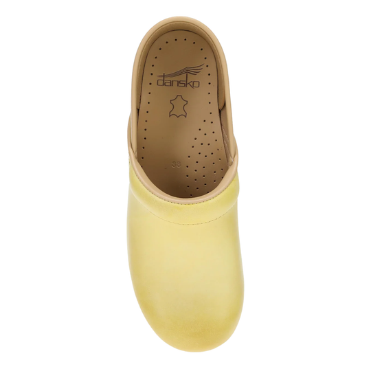 Yellow clog shoe with brown insole on a white background