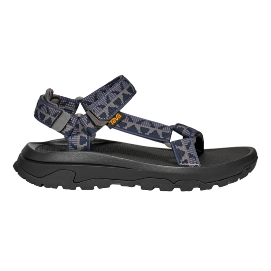 Black sandal with patterned straps on a white background