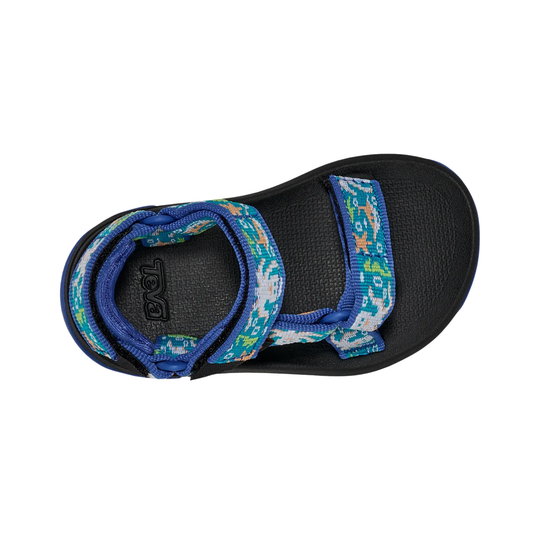 Blue and black sandal with patterned straps on a white background