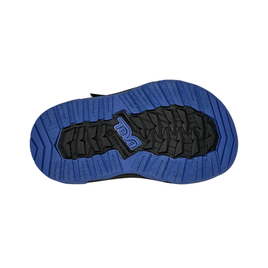 Blue and black sole of a shoe with a brand logo on a white background