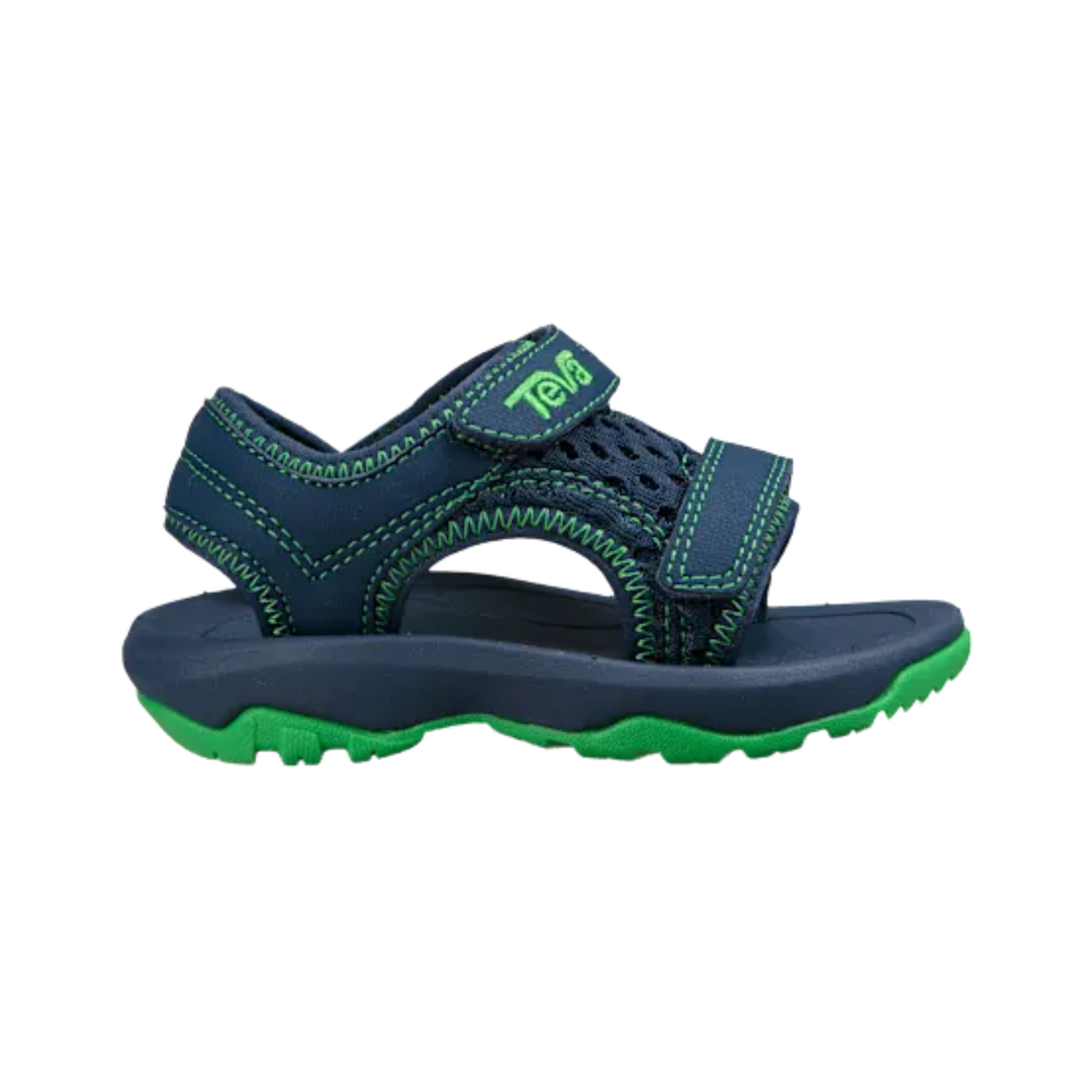 Navy and green sandal with 'Teva' branding on a white background