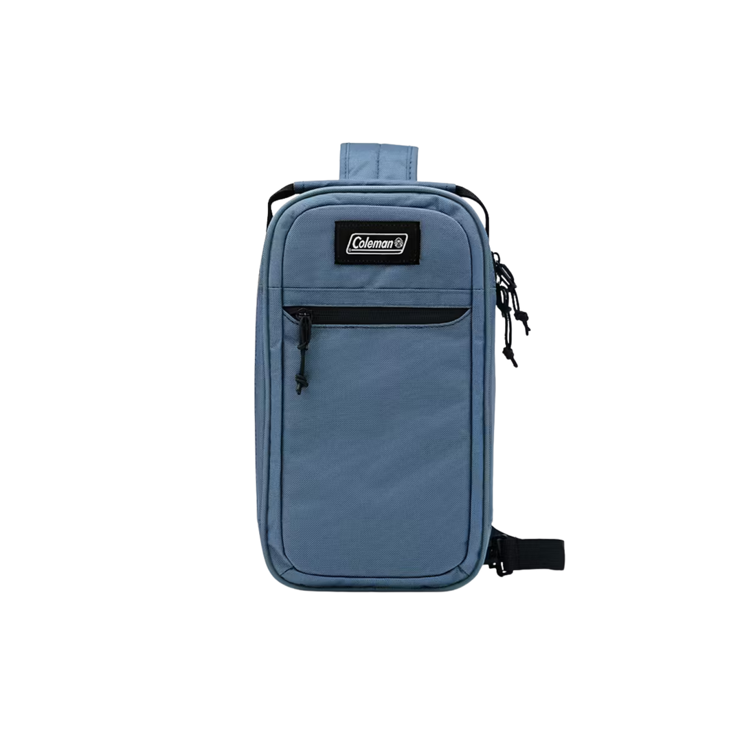 Blue rectangular sling cooler bag with front zip pocket, black straps, and a visible Coleman patch