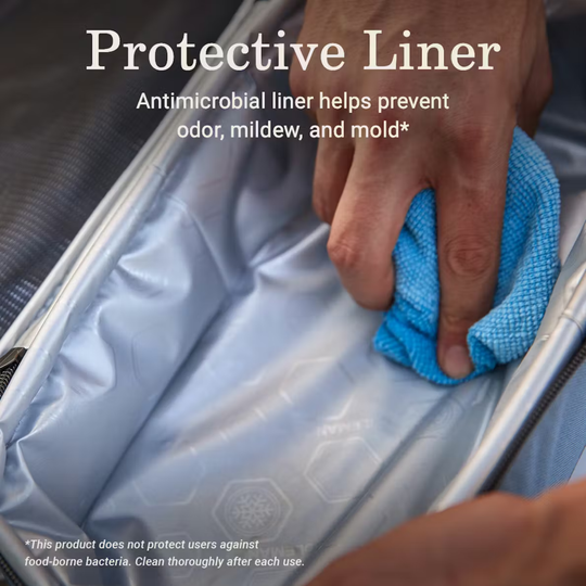 Person cleaning a mattress with a blue cloth, highlighting an antimicrobial liner.