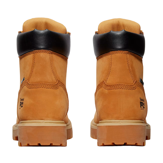 Pair of tan boots with black accents on a white background