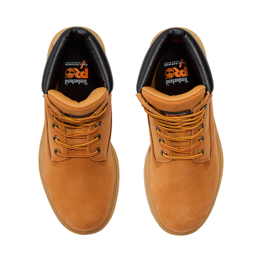 Pair of tan leather boots with orange laces on a white background