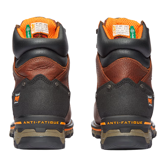 Pair of brown work boots with black soles on a white background