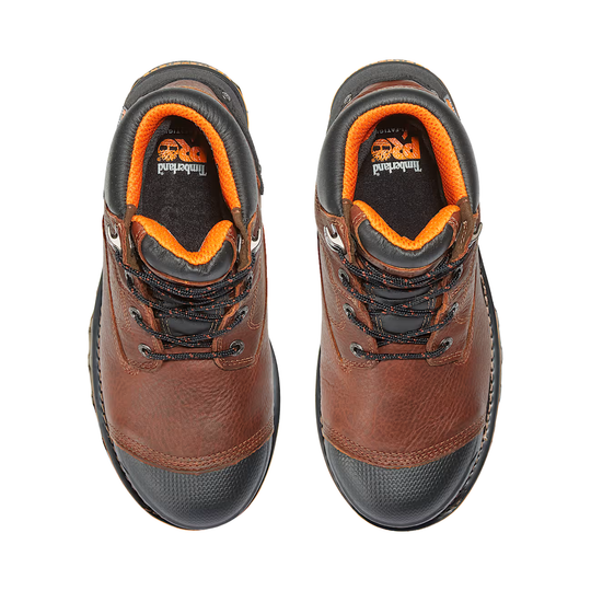Pair of brown leather boots with orange lining on a white background