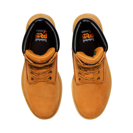 Pair of tan work boots with black soles on a white background
