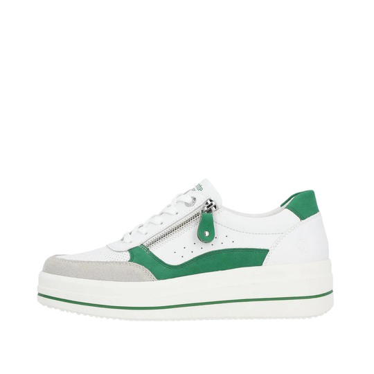 White sneaker with green accents on a white background