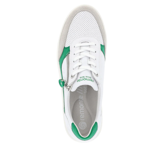 White sneaker with green accents on a white background