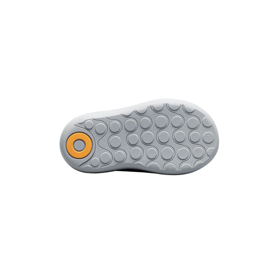 Gray shoe sole with a yellow circular design on a white background