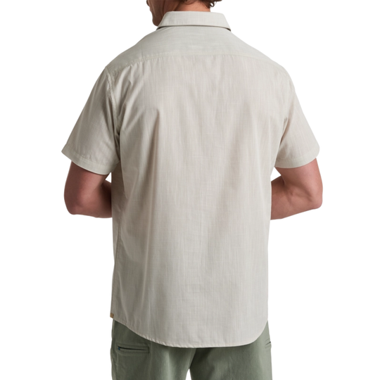 Man wearing a beige short-sleeve shirt on a white background