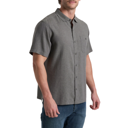Man wearing a gray short-sleeve button-up shirt on a white background