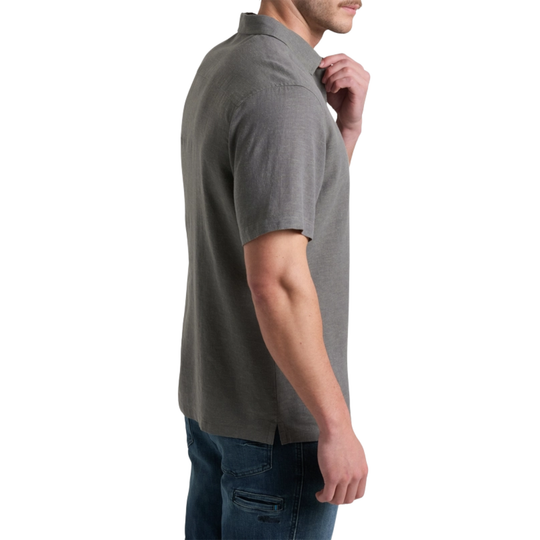 Man wearing a gray polo shirt and jeans on a white background
