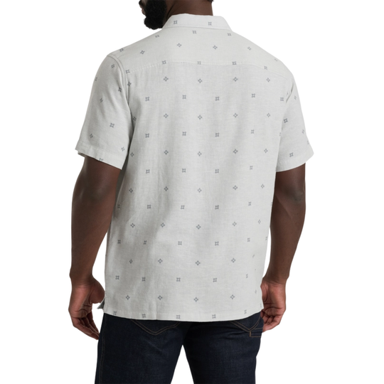 Person wearing a white short-sleeve shirt with a subtle pattern on a white background