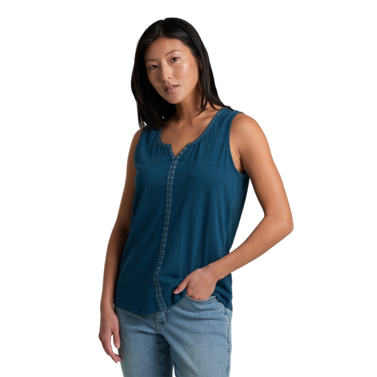 Woman wearing a blue sleeveless top and jeans on a white background