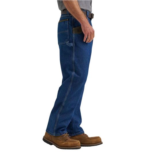 Person wearing blue jeans and brown boots on a white background