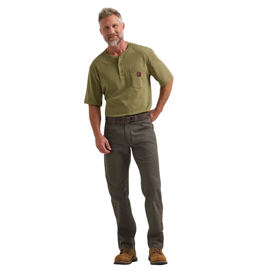 Man wearing a green shirt and brown pants on a white background