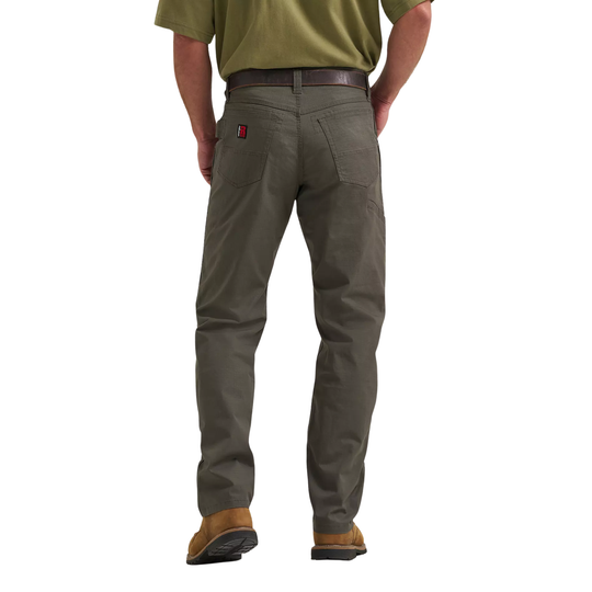 Person wearing green shirt and gray pants on a white background