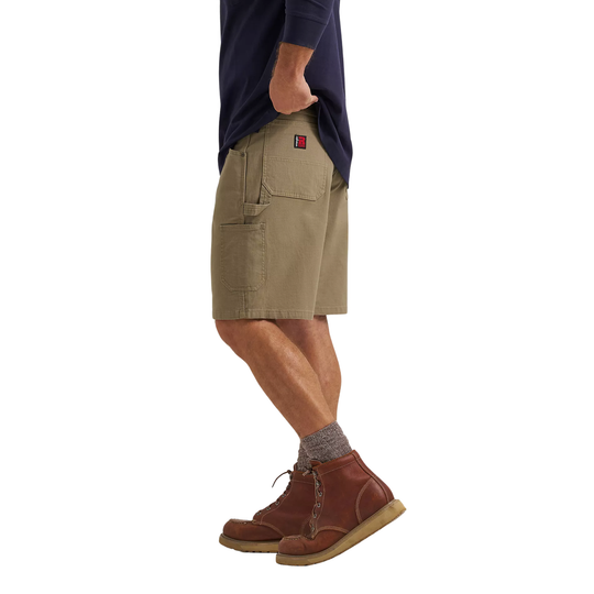 Person wearing beige shorts and brown boots on a white background