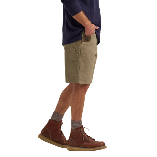 Person wearing beige cargo shorts, brown boots, and a navy shirt on a white background