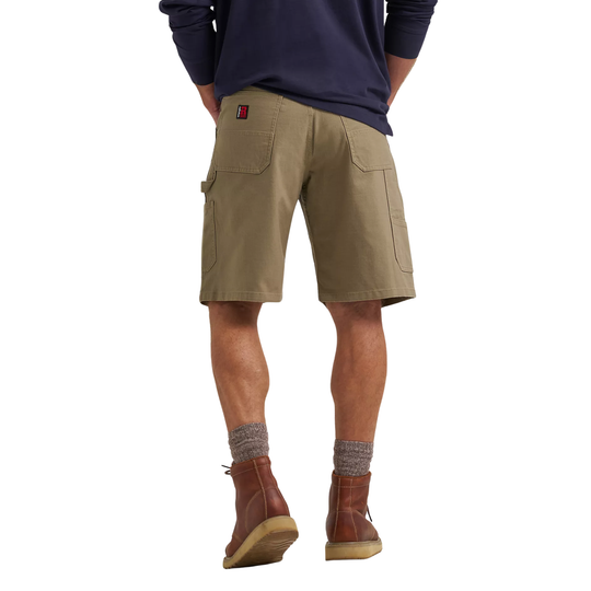 Person wearing khaki cargo shorts and brown boots on a white background
