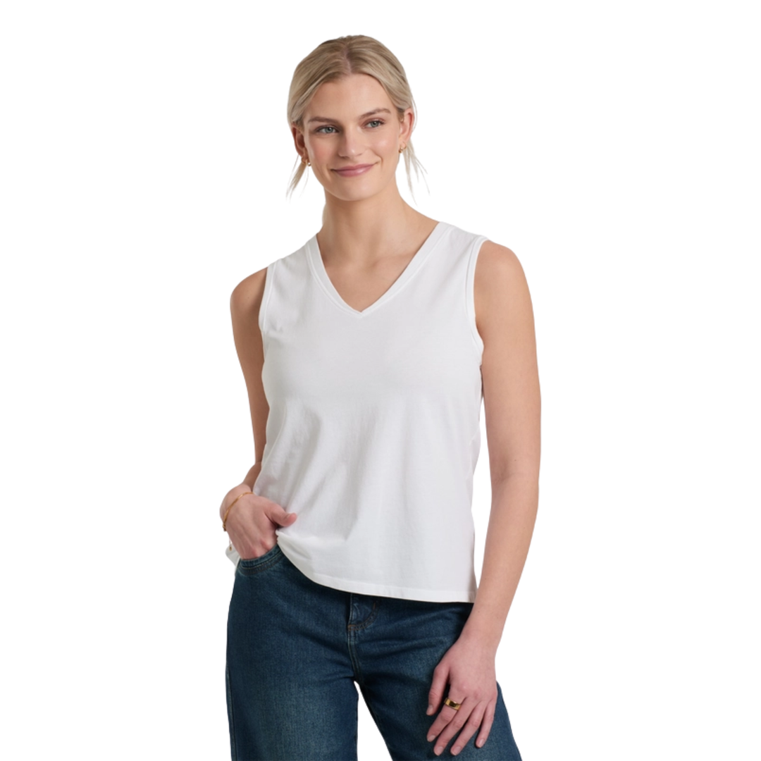 Woman wearing a white sleeveless top and blue jeans on a white background