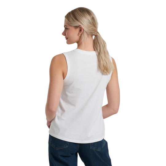Woman wearing a white sleeveless top and blue jeans on a white background