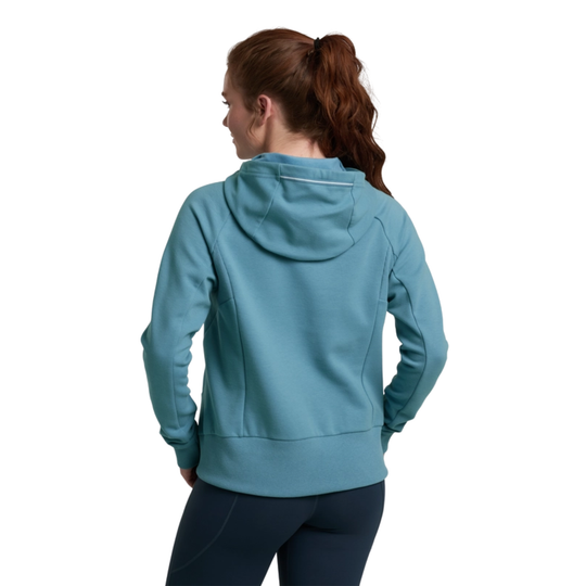 Person wearing a teal hoodie on a white background