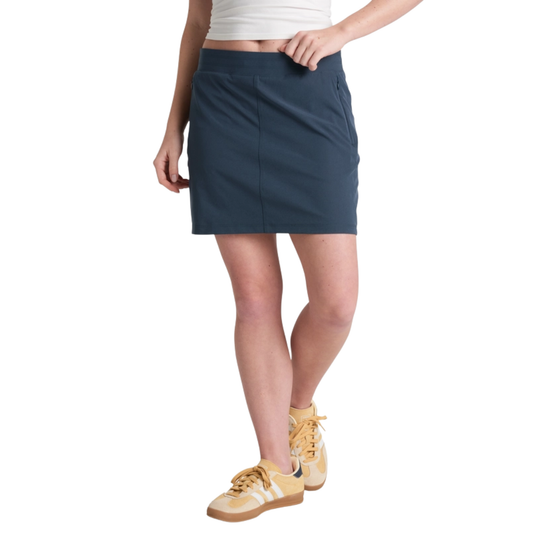 Person wearing a navy skirt with a white background