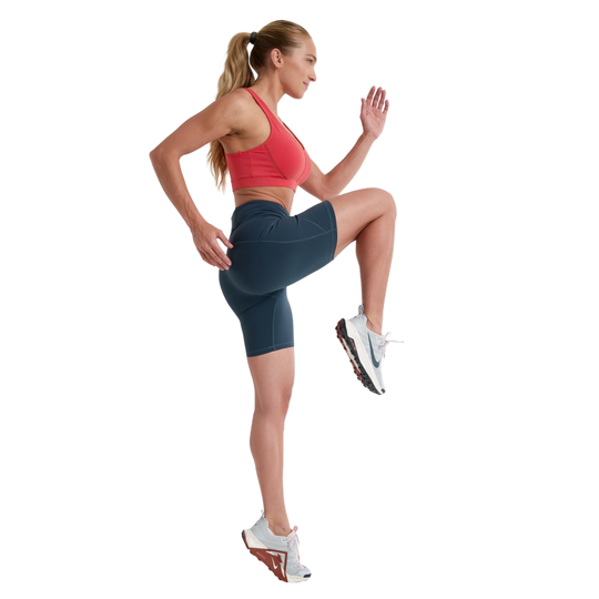 Woman in athletic wear posing on a white background