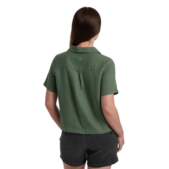 Person wearing a green shirt and black shorts on a white background