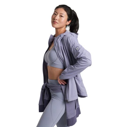 Woman wearing a light purple athletic outfit on a white background