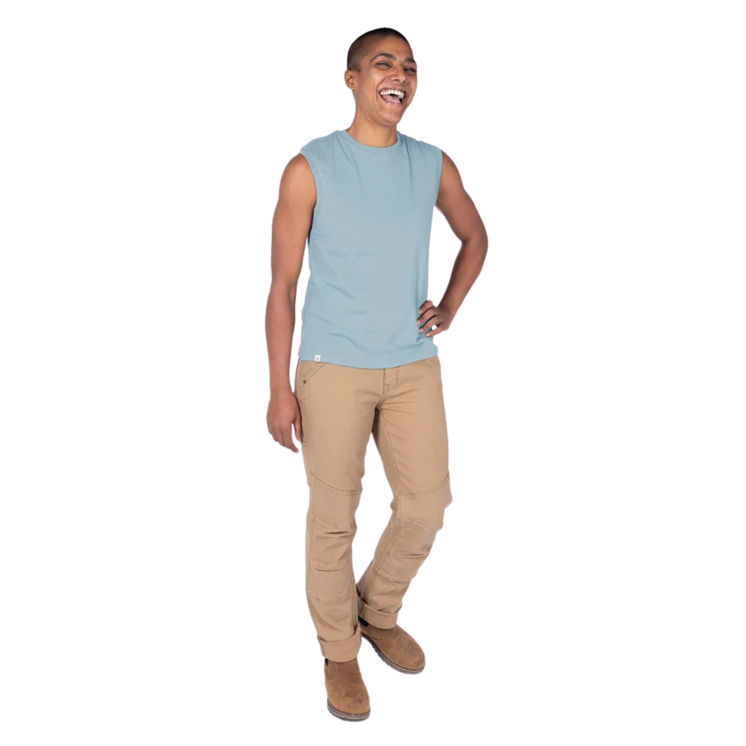 Person wearing a light blue sleeveless shirt and beige pants on a white background